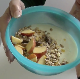 A woman wearing glasses prepares a healthy mixed cereal breakfast, but not before adding her own dose of insoluble dietary fiber! Presented in 720P HD. Over 1.5 minutes.